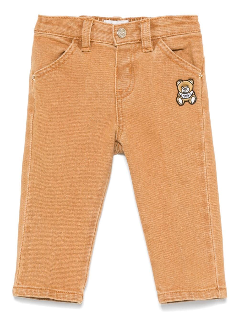 Jeans Leo Teddy per neonato Moschino Kids beige con passanti per cintura – Accessorio premium elegante