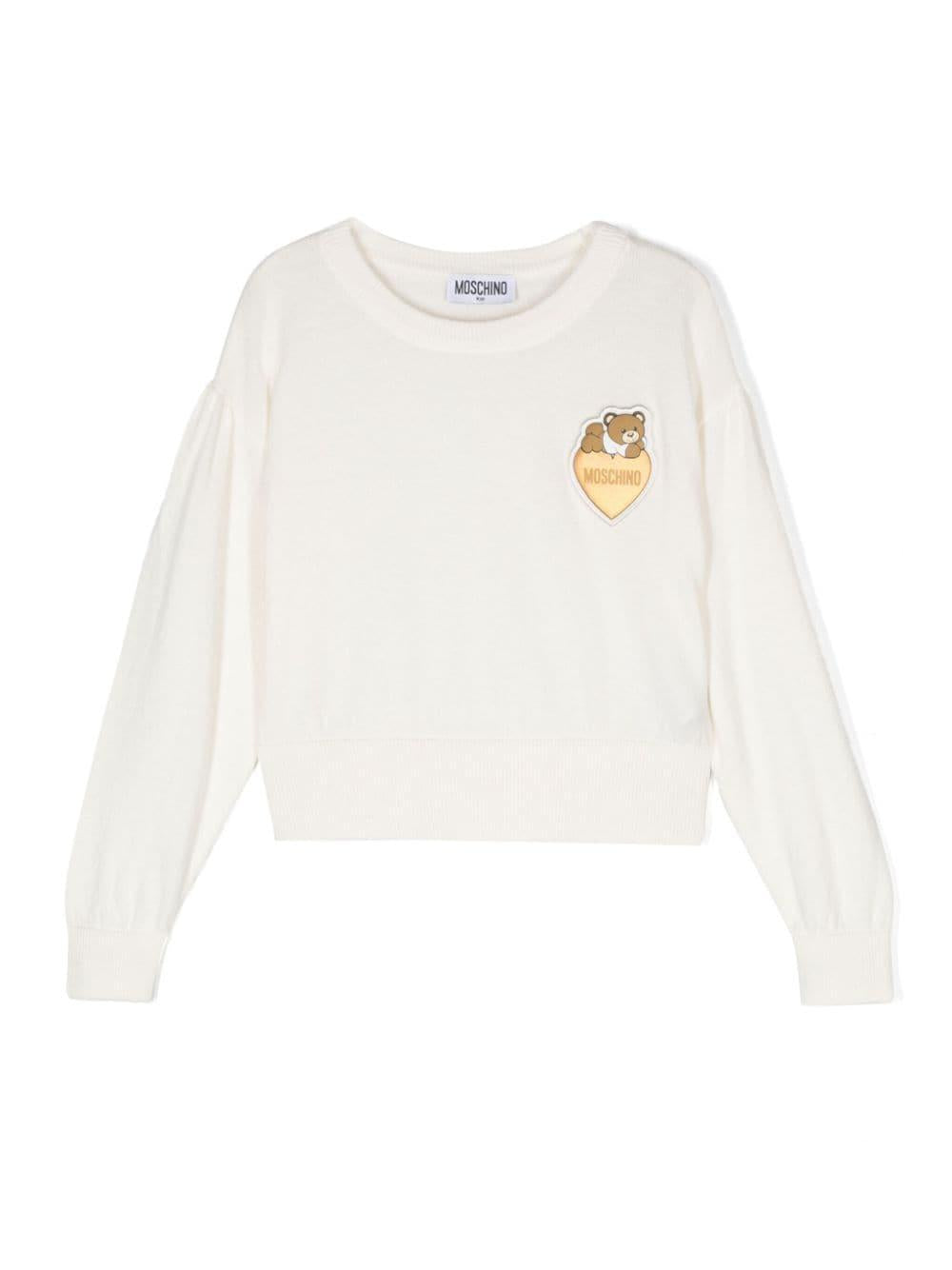 Maglione per bambina Moschino Kids bianco con applicazione Teddy Bear – Accessorio premium elegante
