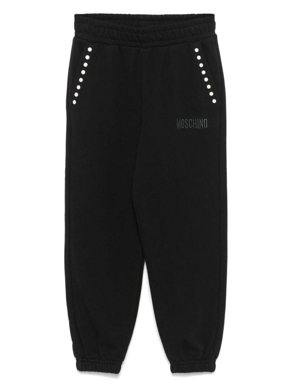 Pantaloni sportivi con borchie per bambina Moschino Kids neri con dettaglio borchiato – Accessorio premium elegante